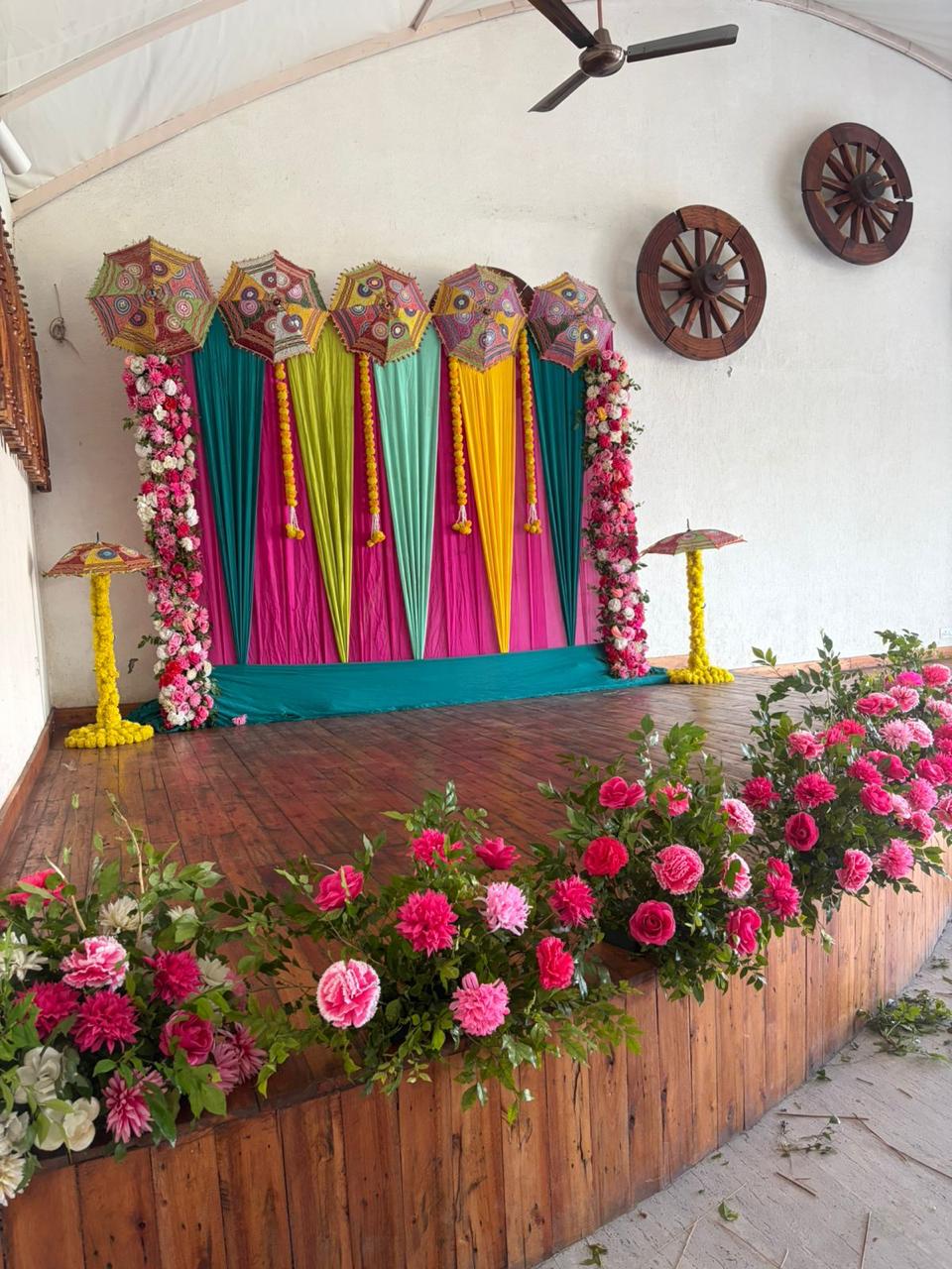 Colorful Mehndi Stage Decoration with Floral & Umbrella Theme